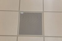 White 2¿ x 2¿ tile mounted in the ceiling to provide microphone coverage over student seating
