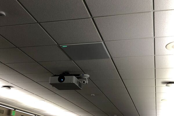 Camera mounted to ceiling and instructor enabled adjustments to the lens to allow the instructor to be "seen" by the camera in more locations around the room and 2¿ x 2¿ tile mounted in the ceiling to provide microphone coverage over student seating 