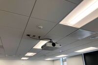 White 2¿ x 2¿ tile mounted in the ceiling to provide microphone coverage over student seating