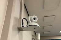 Camera mounted to a wall and instructor enabled adjustments to the lens to allow the instructor to be "seen" by the camera in more locations around the room