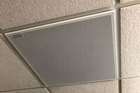 White 2¿ x 2¿ tile mounted in the ceiling to provide microphone coverage over student seating