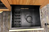 Pedestal - inside view of drawer showing assistive listening devices in charging base