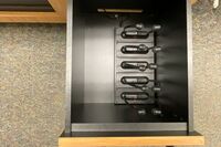 Pedestal - inside view of drawer showing assisted listening devices in charging base