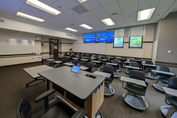 Back of room view of student tablet arm seating and markerboard at rear of room