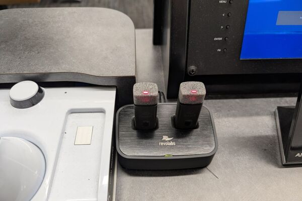 Microphones on top of instructor pedestal with charging base
