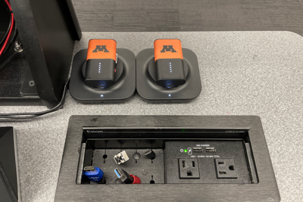 Pedestal - inside view of drawer showing two wireless mics in charging base 