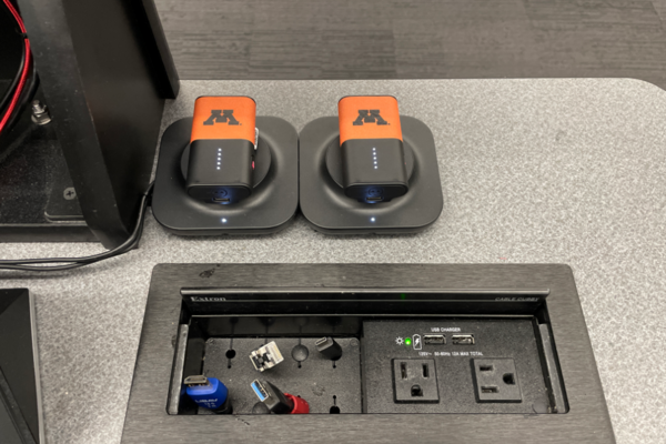 Pedestal - inside view of drawer showing two wireless mics in charging base