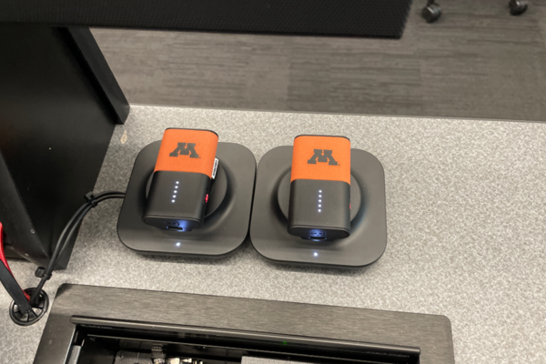 Pedestal - inside view of drawer showing two wireless mics in charging base
