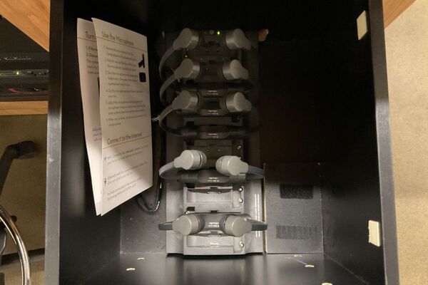 Pedestal - inside view of drawer showing assistive listening devices in charger