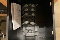 Pedestal - inside view of drawer showing assistive listening devices in charger