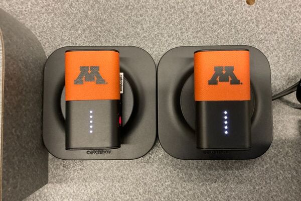 View of microphones in charging base on pedestal