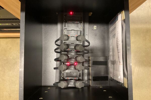 Pedestal - inside view of drawer showing assistive listening devices in charger