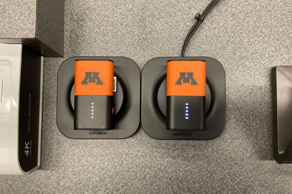 Wireless microphones in charging base on pedestal 