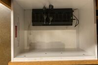 Pedestal - inside view of drawer with assistive listening devices in charger