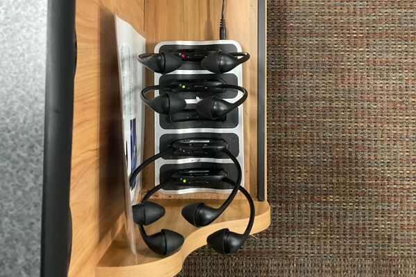 Assisted listening devices charging inside drawer