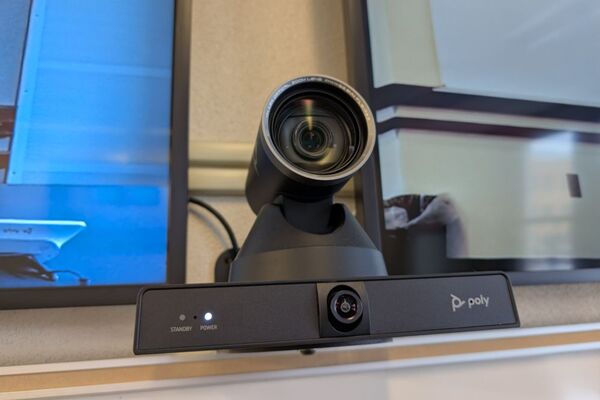 Camera mounted to a wall and instructor enabled adjustments to the lens to allow the instructor to be "seen" by the camera in more locations around the room