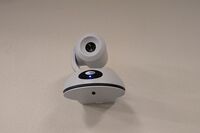 Camera mounted to a wall and instructor enabled adjustments to the lens to allow the instructor to be "seen" by the camera in more locations around the room