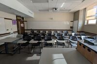 Back of room view with markerboard, and tablet arm seating
