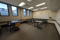 Back of room view of student tablet arm seating and double markerboard at rear of room