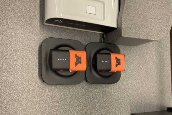 Pedestal - view of pocket showing two wireless mics in charging base