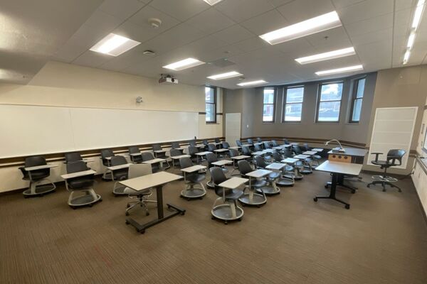 Back of room view of student tablet arm seating and markerboard on rear wall