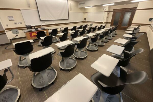 Front of room view with lectern on left in front of markerboard 