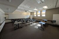 Back of room view of student tablet arm seating and markerboard at rear of room