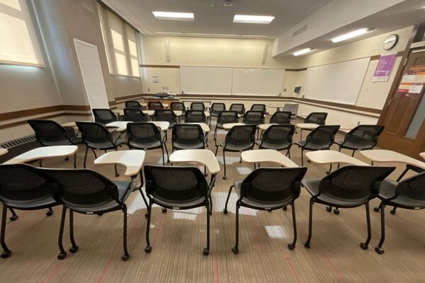 Front of room view with lectern on left in front of markerboard 