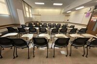 Front of room view with lectern on left in front of markerboard 