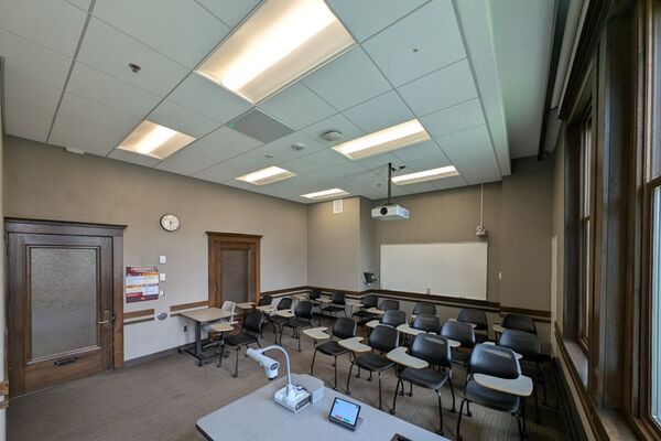Back of room view of student tablet arm seating and markerboard on rear wall