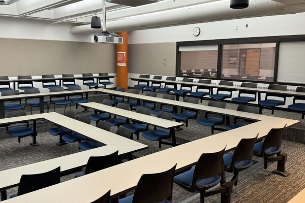 Back of room view of student tiered fixed-table and chair seating