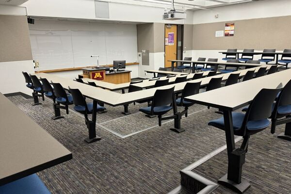 Front of room view with lectern center in front of markerboard and exit door on the right