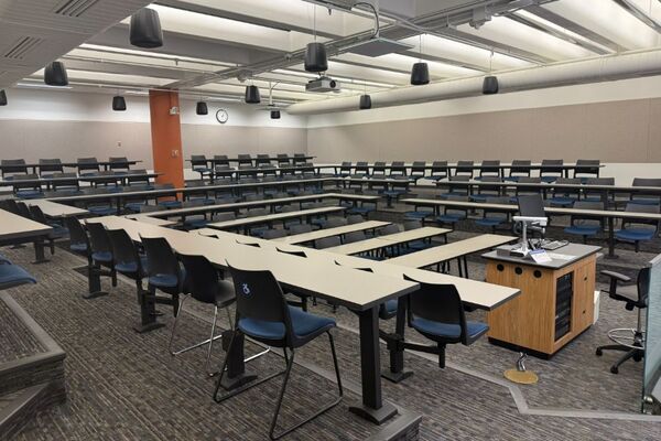 Back of room view of student fixed table and chair seating
