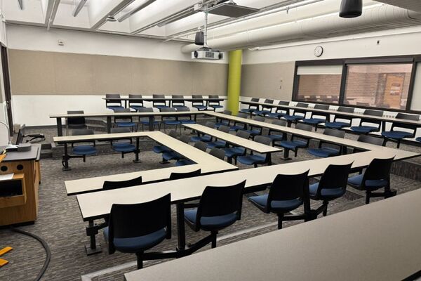Back of room view of student fixed-table and chair seating 