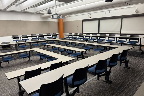 Back of room view of student tiered fixed table and chair seating 