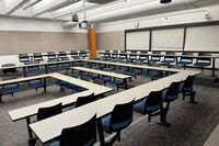 Back of room view of student tiered fixed table and chair seating 