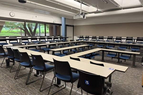 Back of room view of student tiered fixed table and chair seating