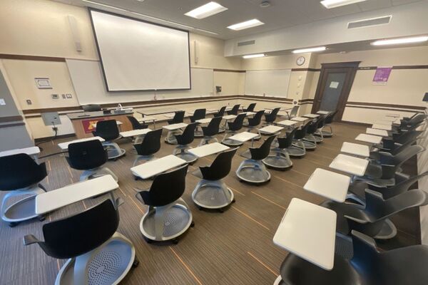 Front of room view with lectern on left in front of markerboard 