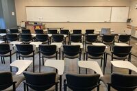 Front of room view with lectern on left in front of markerboard 