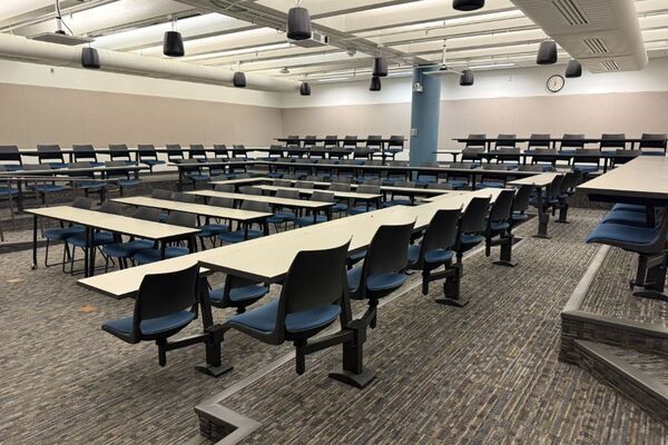 Back of room view of student tiered fixed table and chair seating 
