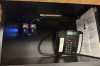 Pedestal - inside view of drawer showing two wireless mics in charging base and telephone