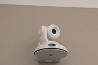 Camera mounted to a wall and instructor enabled adjustments to the lens to allow the instructor to be "seen" by the camera in more locations around the room