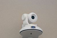 Camera mounted to a wall and instructor enabled adjustments to the lens to allow the instructor to be "seen" by the camera in more locations around the room