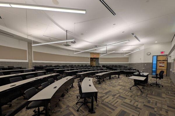 Back of room view of student tiered fixed-table and chair seating 