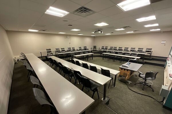 Back of room view of student tiered fixed table and chair seating