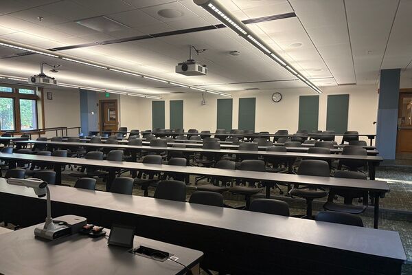 Front of room view with lectern on left in front of markerboard