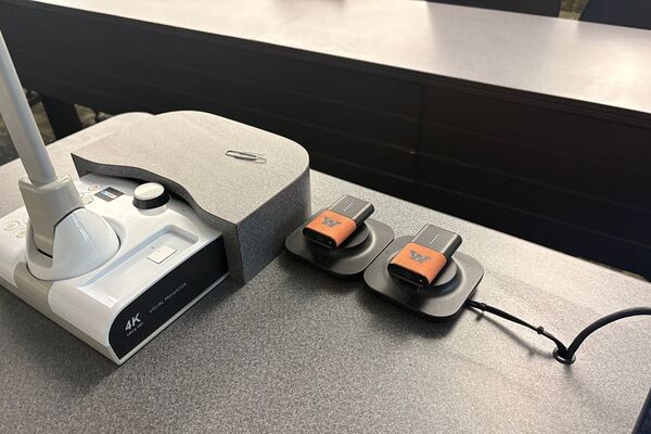Microphones on top of instructor pedestal with charging base