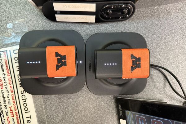 Microphones on top of instructor pedestal with charging base