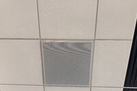 White 2 x 2 tile mounted in the ceiling to provide microphone coverage over student seating