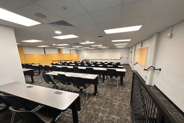 Front of room view with lectern on left in front of markerboard